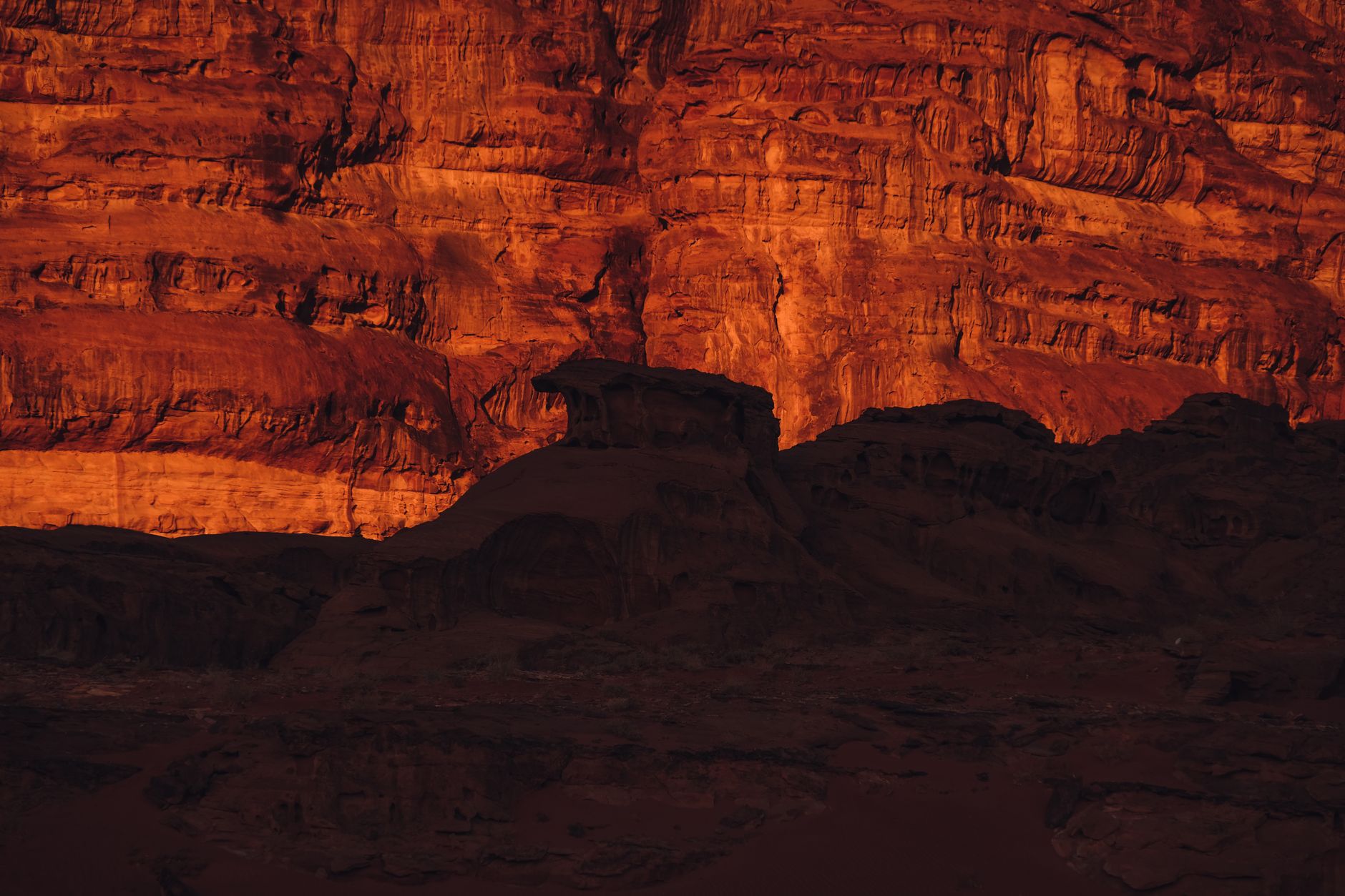 Backpack and navigation map resting on arid canyon sandstone